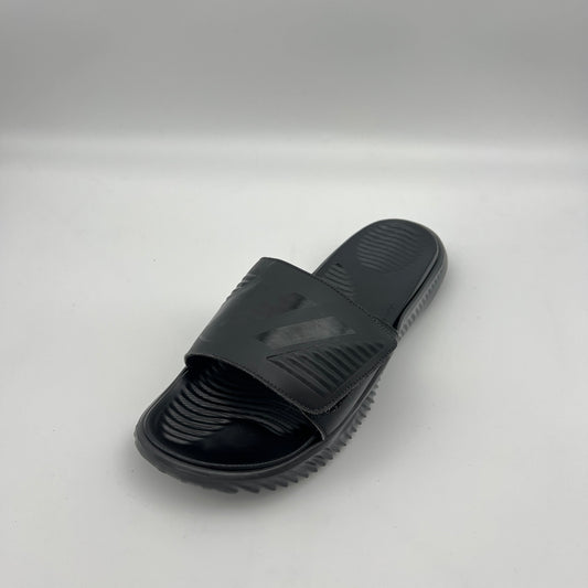 A side profile of an all-black Adidas Alphabounce slide featuring an adjustable strap with debossed branding and a thick, contoured Bounce cushioned sole.