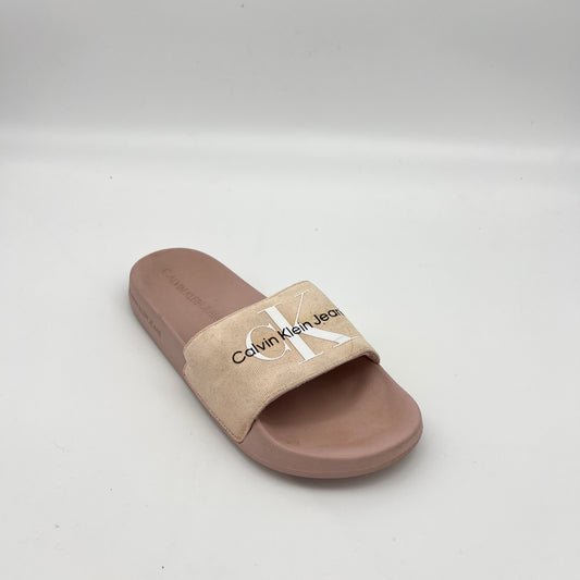Women's Calvin Klein designer slides featuring a canvas strap and embossed footbed logo.