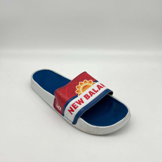 Blue and red slide sandal with New Balance logo on a white background
