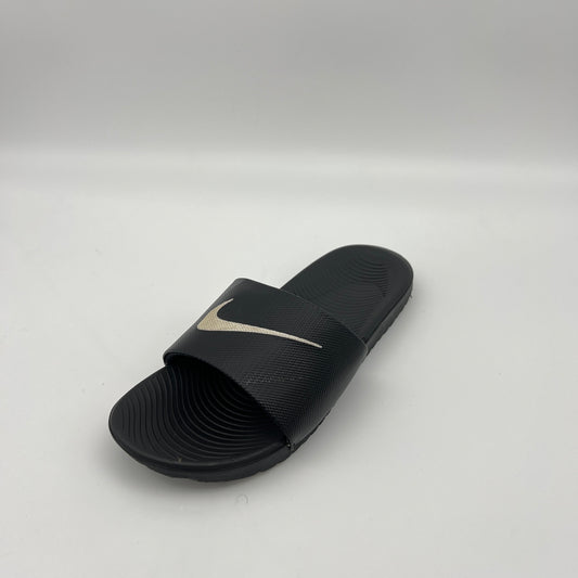 Black slide sandal with a logo on a light gray background