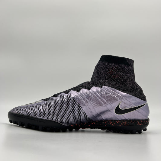 Profile view of a Nike MercurialX Proximo TF turf football boot in metallic Urban Lilac with a black Flyknit Dynamic Fit collar and a speckled outsole