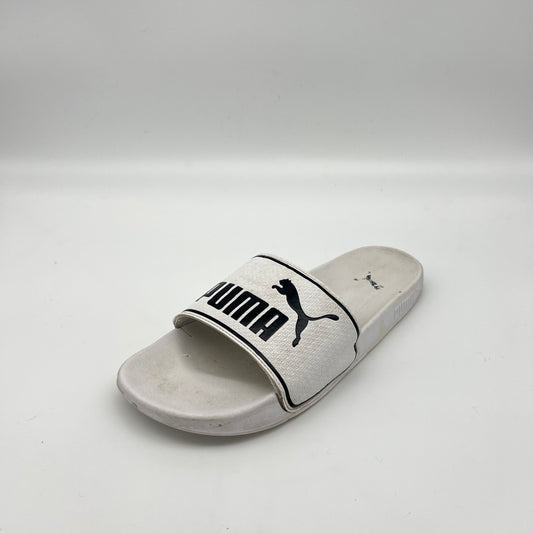 White slide sandal with Puma logo on a light gray background