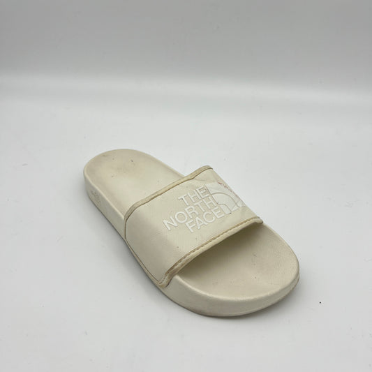 Beige sandal with 'The North Face' logo on a white background