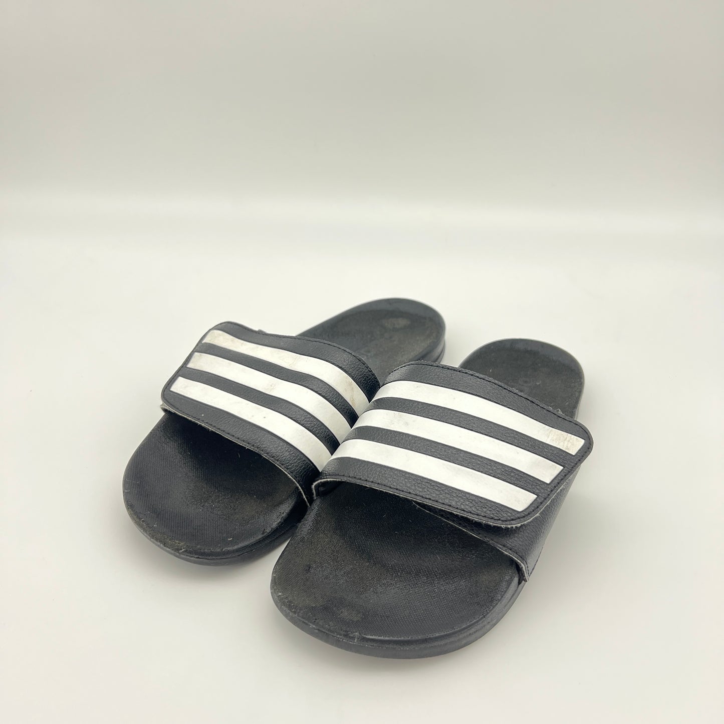 Black slides with white stripes on a light gray background