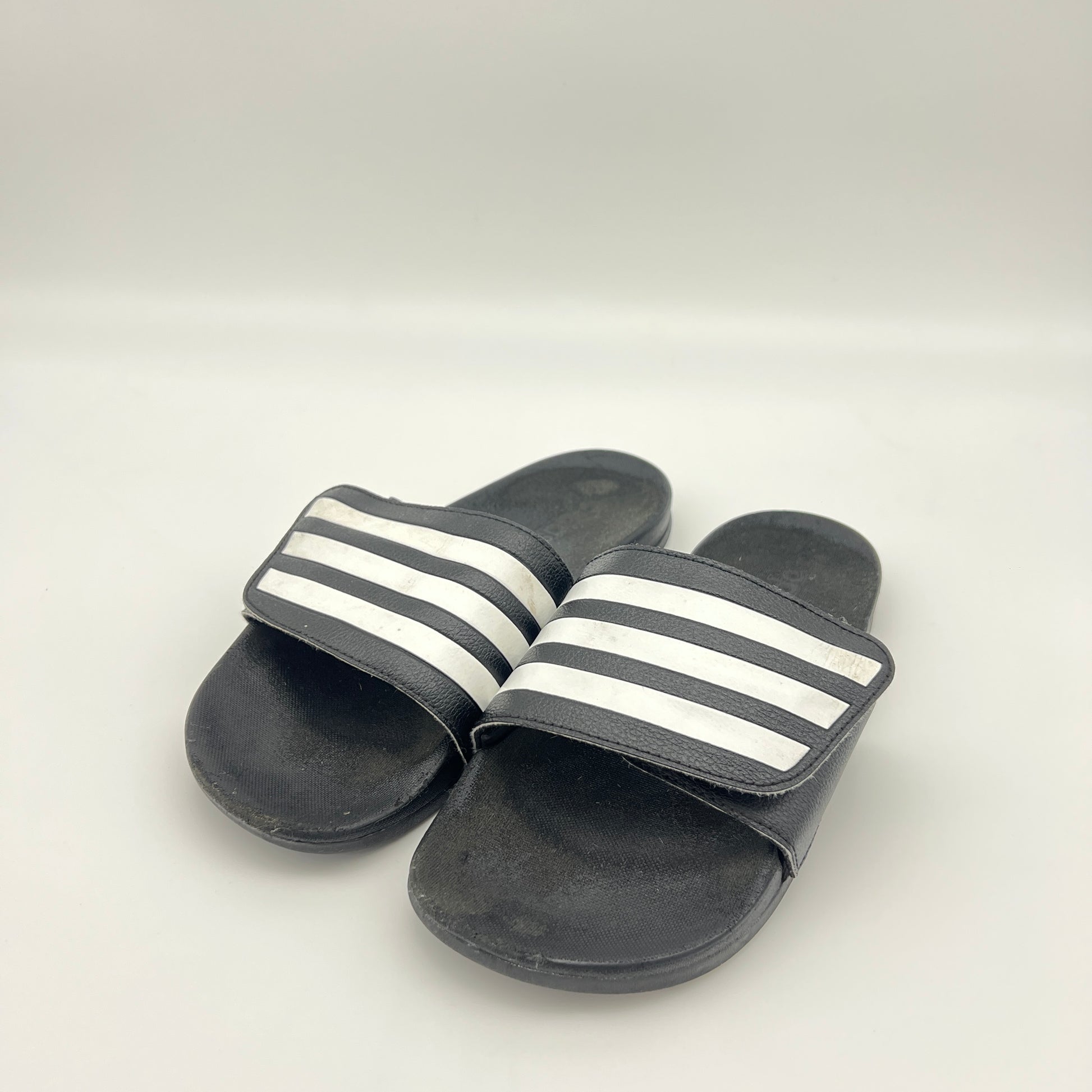 Black slides with white stripes on a light gray background