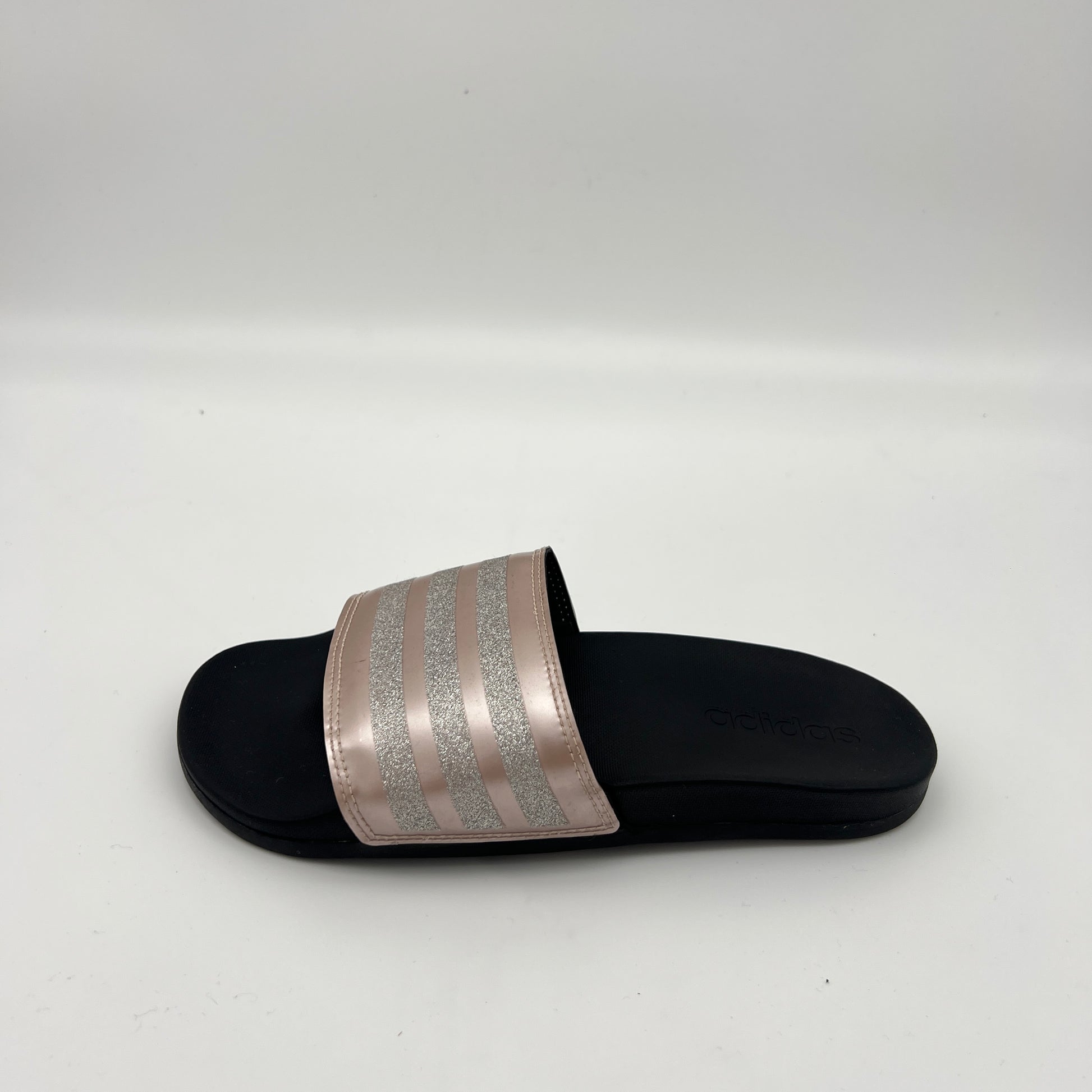 Rose gold Adidas Adilette Comfort slide sandal with silver glitter stripes and black footbed