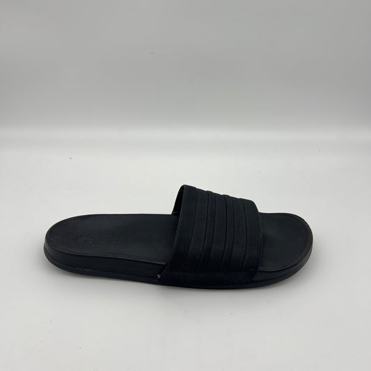 All-black Adidas Adilette Comfort slide sandal with tonal three-stripes and a plush footbed.