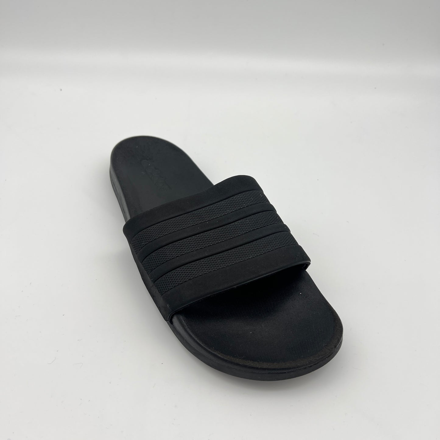 Black slide sandal on a white background