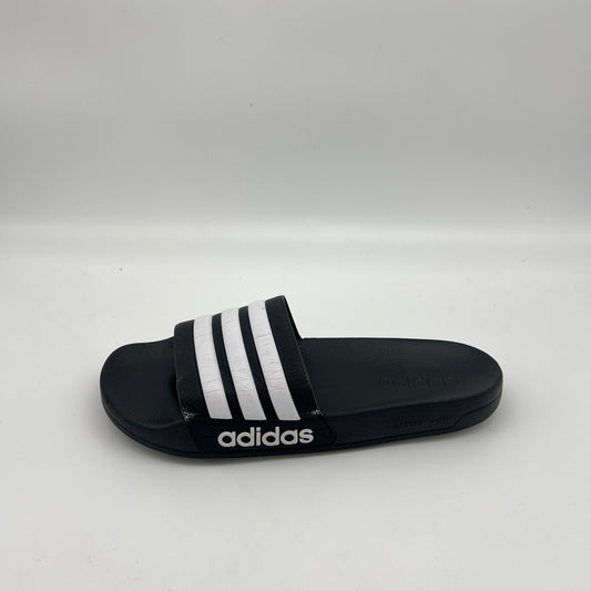 Side view of a black Adidas Adilette Shower slide featuring white three-stripes and a Cloudfoam sole
