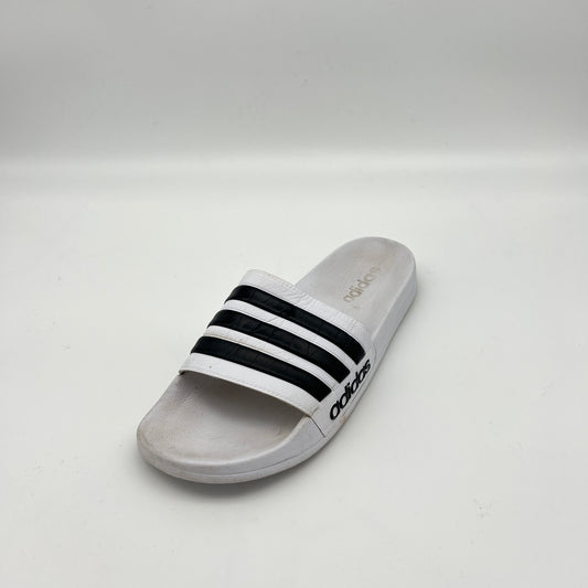 Gray Adidas slide sandal with black stripes on a white background