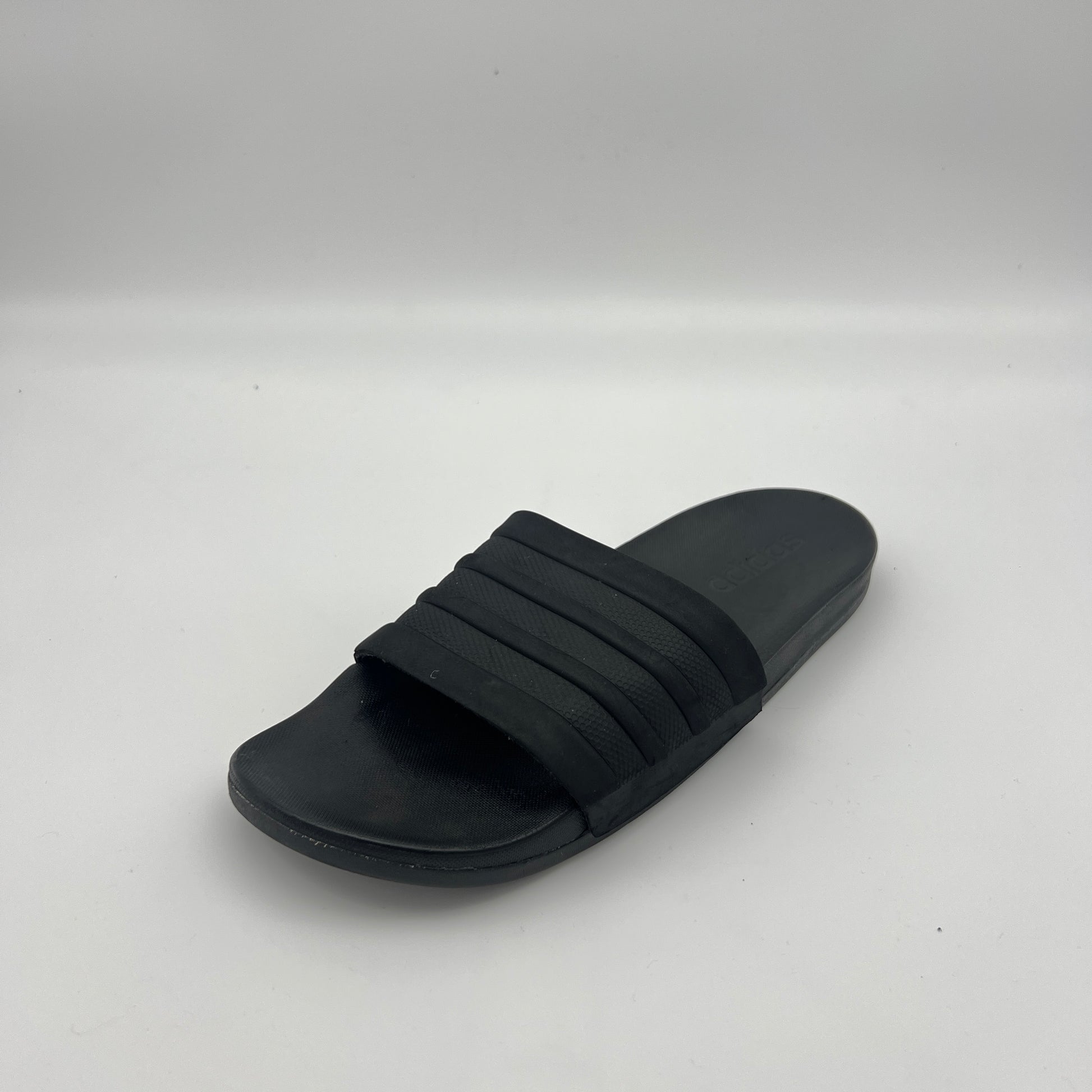 Black slide sandal on a white background