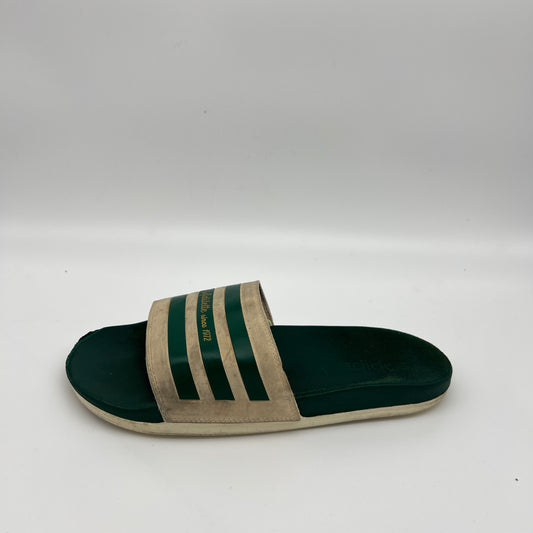 Adidas Adilette Since 1972 slides in off-white and forest green.