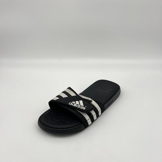 Black Adidas slide sandal on a white background
