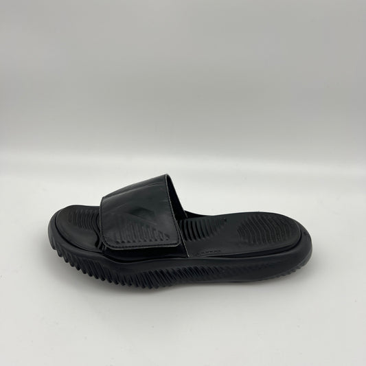 Side view of an all-black Adidas Alphabounce slide sandal on a white background showing the textured footbed and adjustable 3-stripes strap.