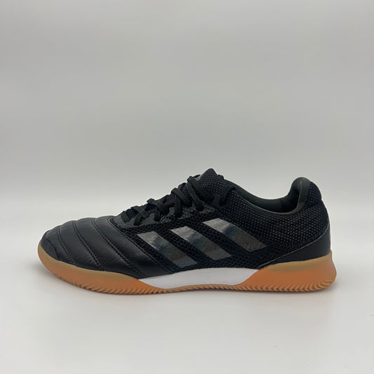 Side view of a black Adidas Copa 19.3 indoor soccer shoe with tonal three stripes, a white midsole, and a tan gum sole on a gray background.