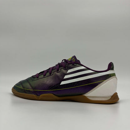 Side profile of a purple Adidas F10 indoor soccer shoe with white stripes and a gum rubber sole