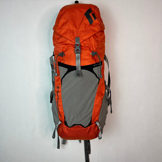 Front view of a Black Diamond Axiom 30 liter technical hiking backpack in burnt orange and grey, featuring adjustable compression straps and a spacious lid.