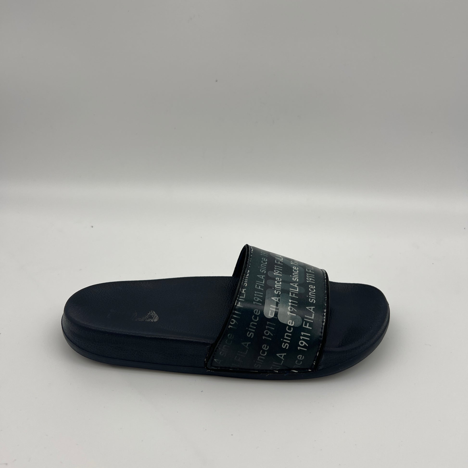 Navy blue Fila Drifter slides with white repeating logo script.