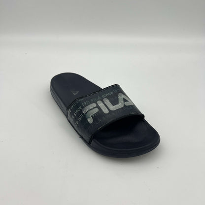 Side view of navy Fila sandals featuring "FILA since 1911" printed repeatedly across the synthetic strap