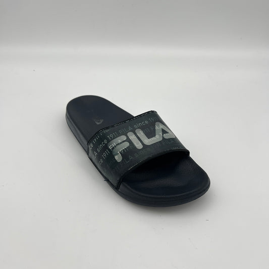 Side view of navy Fila sandals featuring "FILA since 1911" printed repeatedly across the synthetic strap