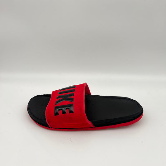 Side profile of a University Red Nike Offcourt Slide with a black footbed and a red synthetic strap featuring a bold, black Nike logo on a white background.