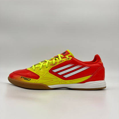 Side view of orange and yellow Adidas F10 IN indoor soccer shoe with white stripes.