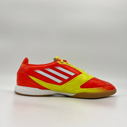 Red and yellow Adidas sports shoe on a gray background