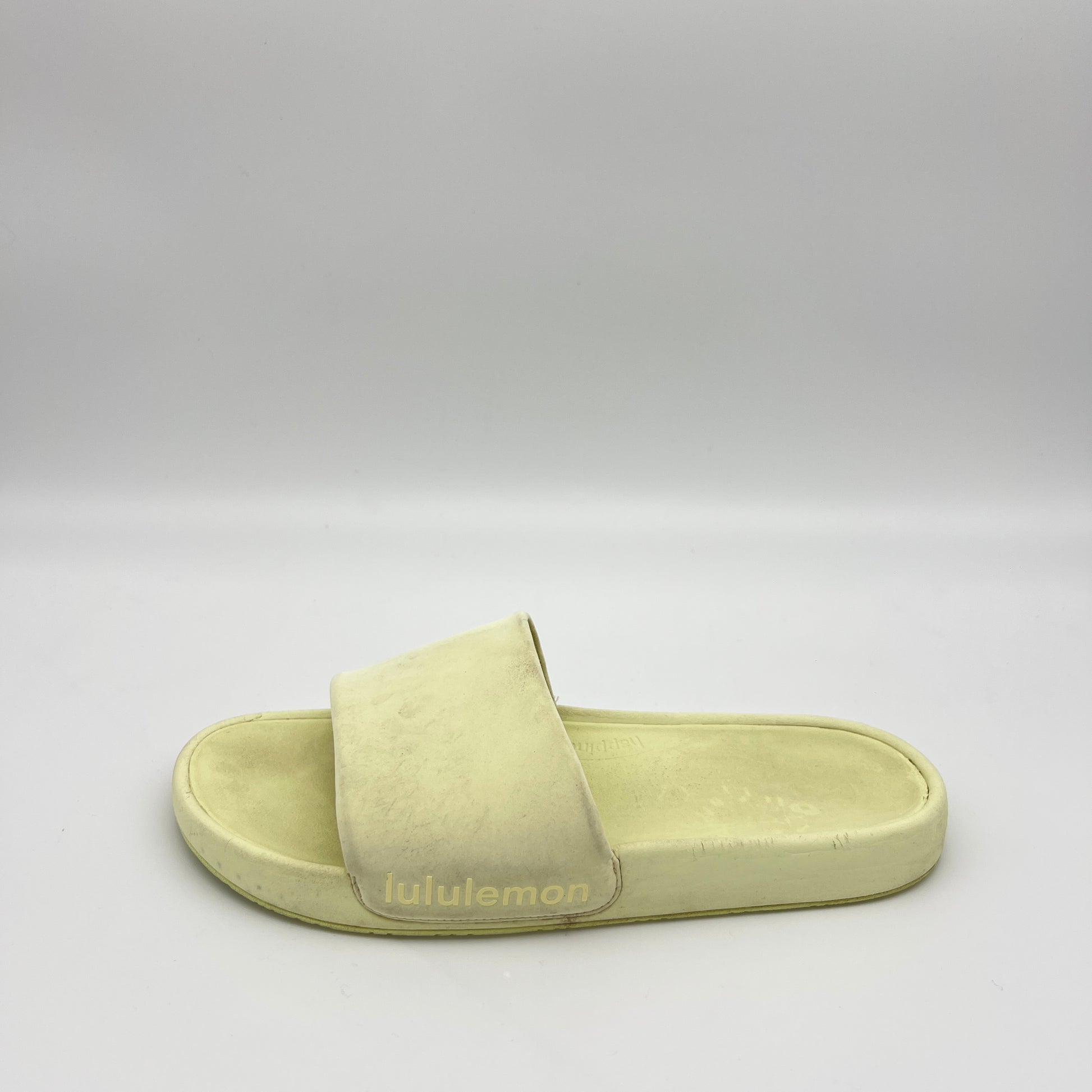 Light green slide sandal with 'lululemon' branding on a gray background