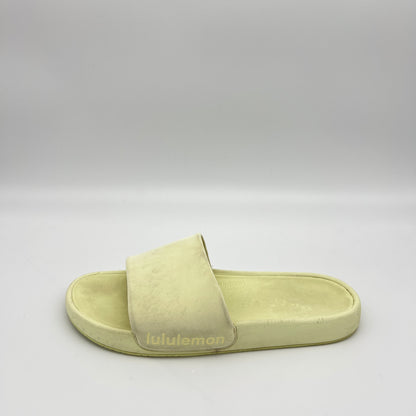 Light green slide sandal with 'lululemon' branding on a gray background