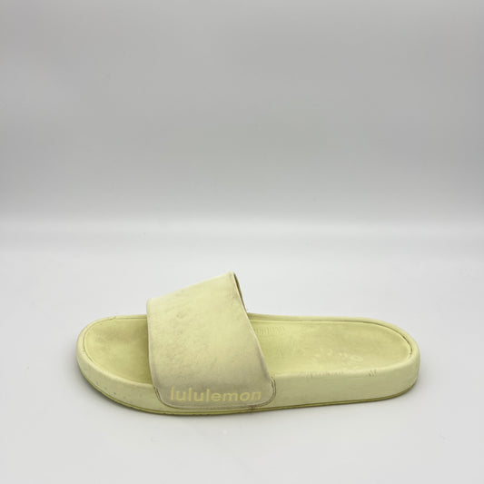 Light green slide sandal with 'lululemon' branding on a gray background