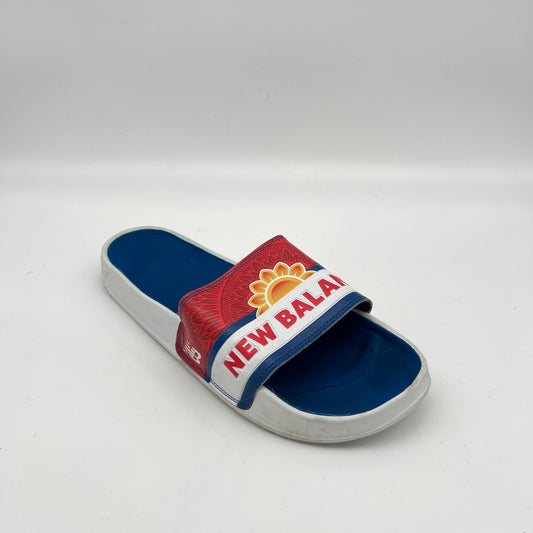 Blue and red slide sandal with New Balance logo on a white background