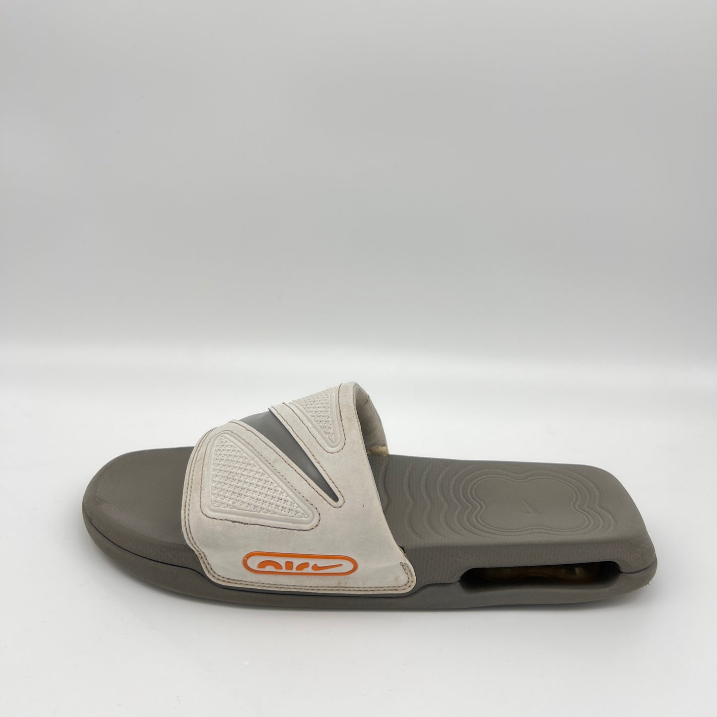 Gray slide sandal with a brand logo on a white background