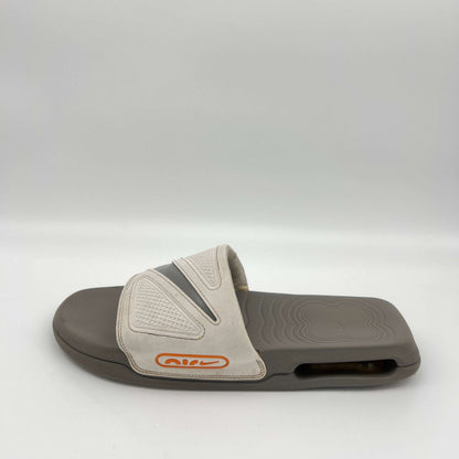Gray slide sandal with a brand logo on a white background