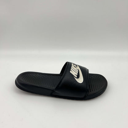 Black slide sandal with Nike logo on a white background