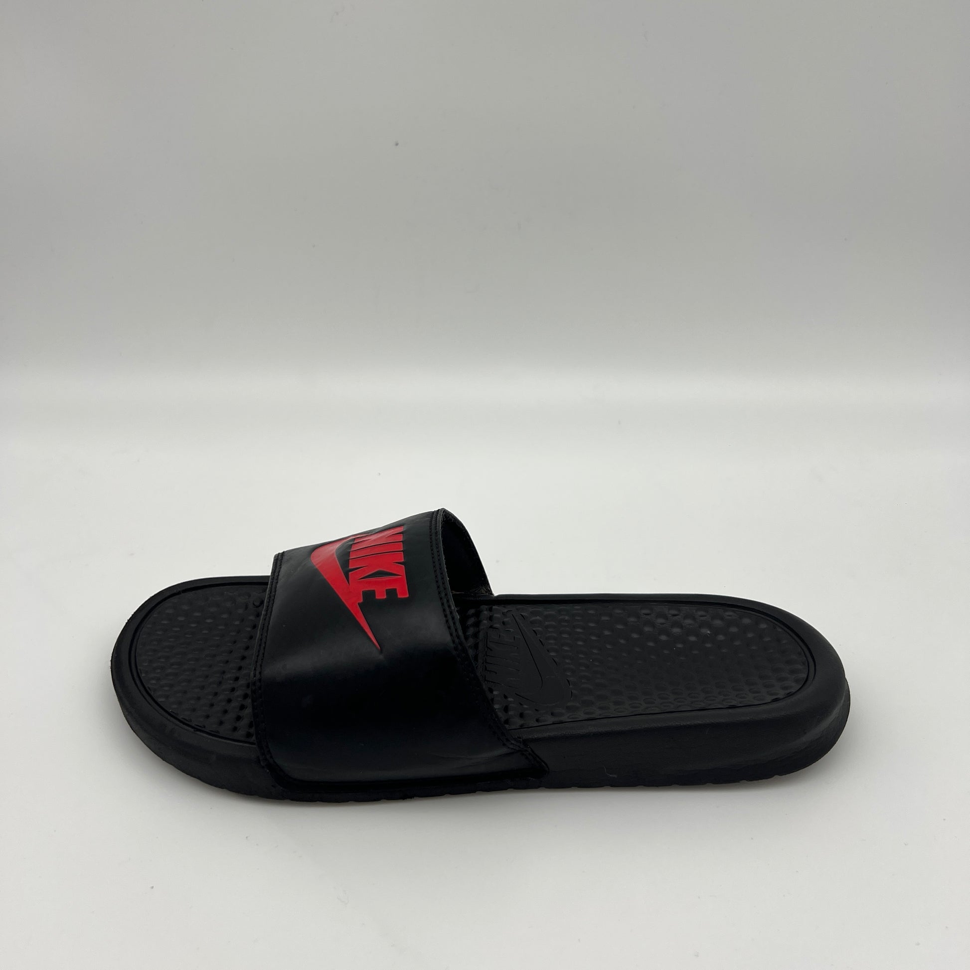 Nike Benassi JDI men's slides in black with red Nike logo