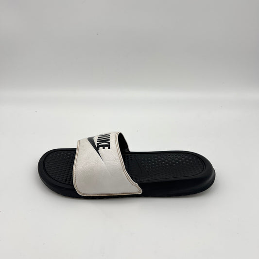 Side view of Nike Benassi JDI slide sandal in white and black with a contoured footbed.