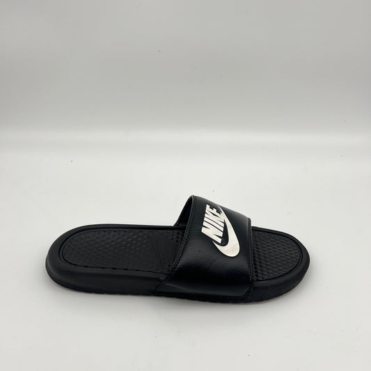 Side view of Nike Benassi JDI slide sandal in black and white with a textured footbed