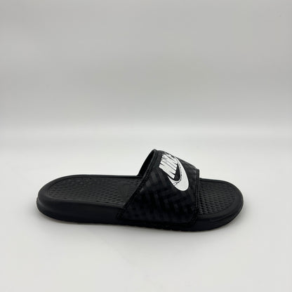 Side profile of black Nike Benassi JDI women's slides with a white Nike logo and diamond-patterned strap