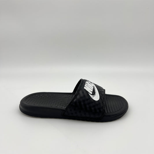 Side profile of black Nike Benassi JDI women's slides with a white Nike logo and diamond-patterned strap
