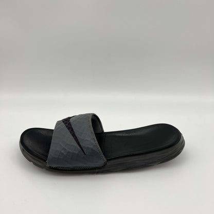 Nike Benassi Solarsoft 2 slide in grey and black featuring a textured, fractal-patterned strap with a black Swoosh and a contoured black footbed.