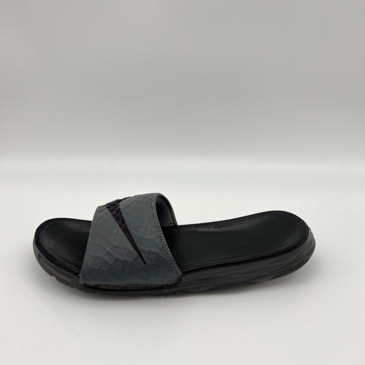 Nike Benassi Solarsoft 2 slide in grey and black featuring a textured, fractal-patterned strap with a black Swoosh and a contoured black footbed.