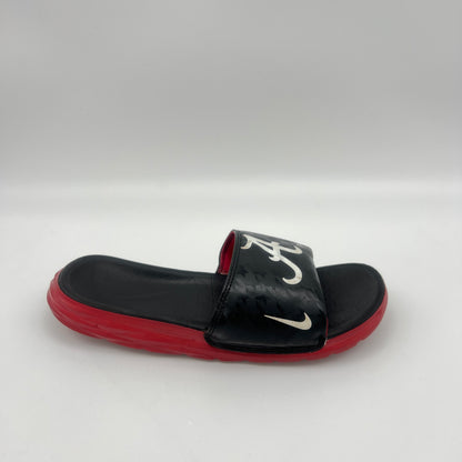 Black and red slide sandal with a logo on a white background