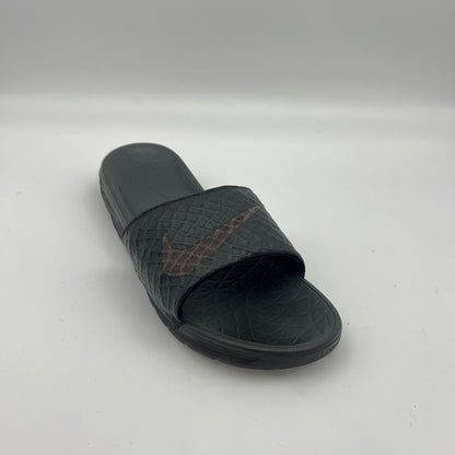 Black slide sandal with a brand logo on a white background