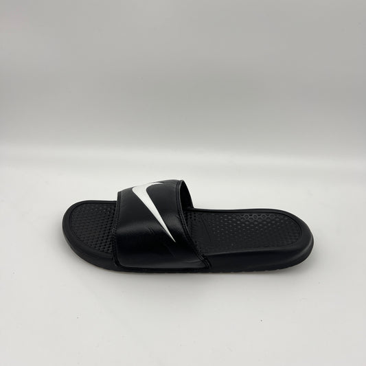 Side profile of a black Nike Benassi Swoosh slide sandal featuring a large white iconic logo on the strap and a textured footbed on a white background.