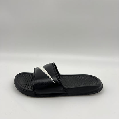 Nike Benassi Swoosh slide in black with a large white Swoosh logo on the synthetic strap and a textured, contoured black footbed.