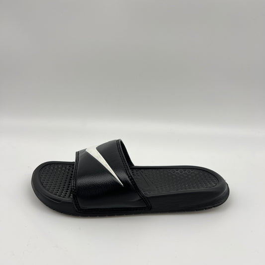 Nike Benassi Swoosh slide in black with a large white Swoosh logo on the synthetic strap and a textured, contoured black footbed.