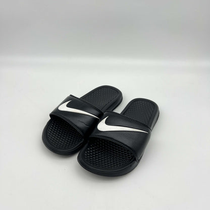 Black slides with white swoosh logo on a light gray background
