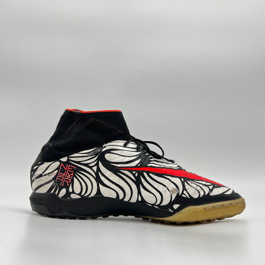 Black, white, and red soccer shoe on a gray background