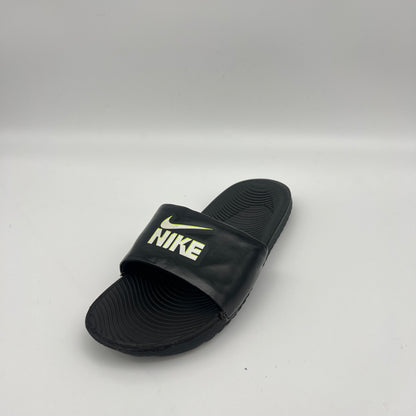 Black Nike slide sandal on a light gray background
