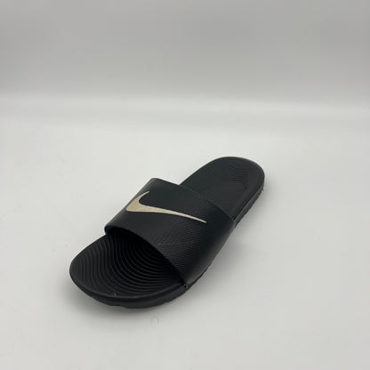 Black slide sandal with a logo on a light gray background